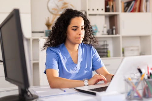 medical assistant performing research on computer